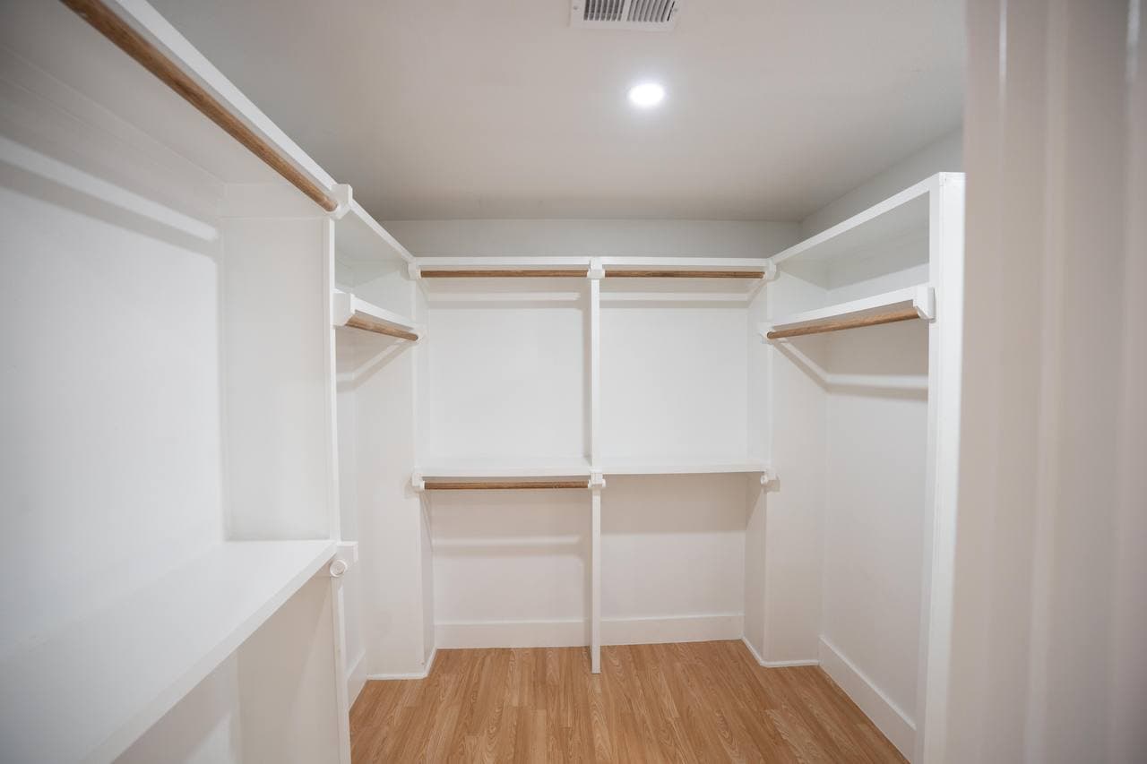 Custom walk-in closet with built-in shelving and hanging rods