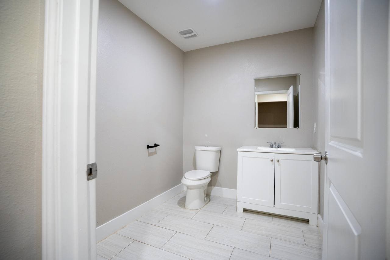 Half bath renovation with tile flooring and new vanity