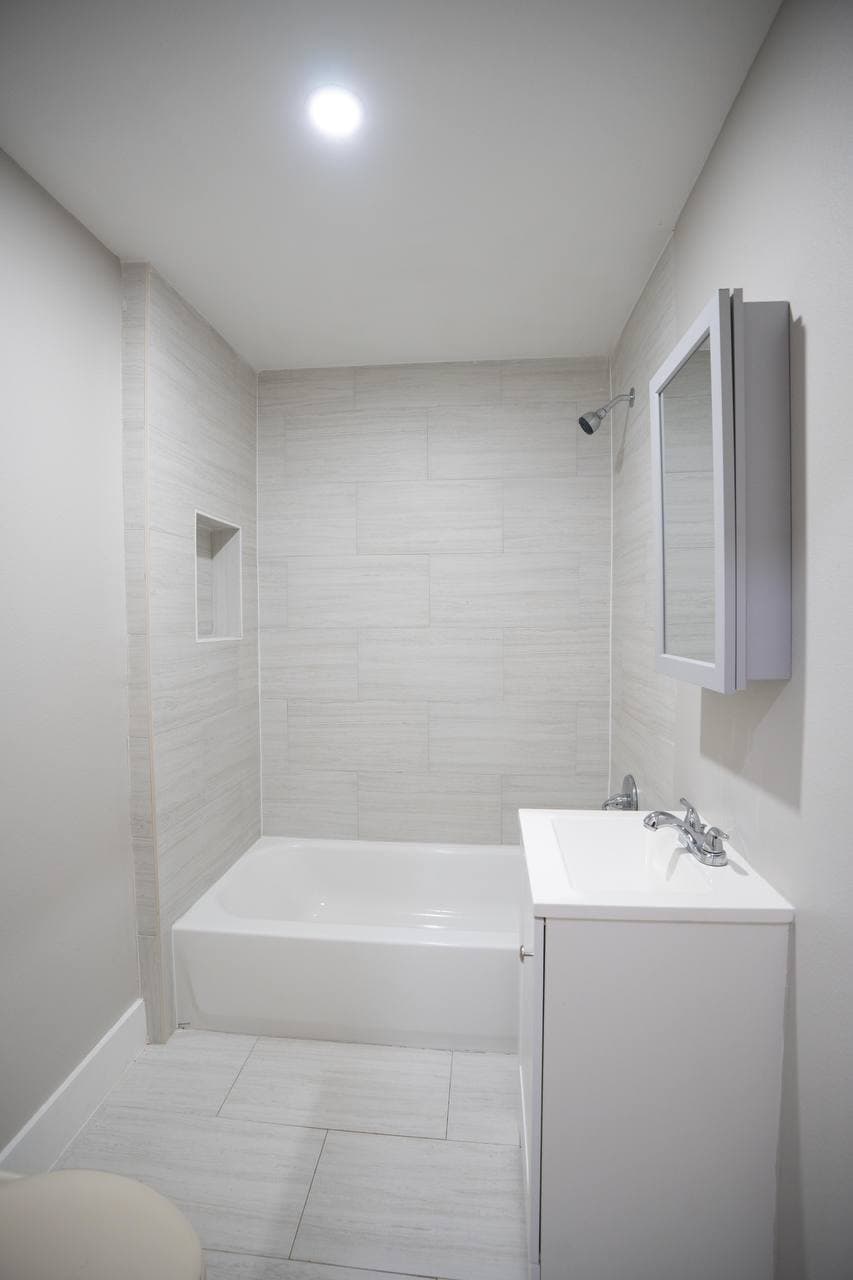 Full bath remodel with soaking tub and large format tile