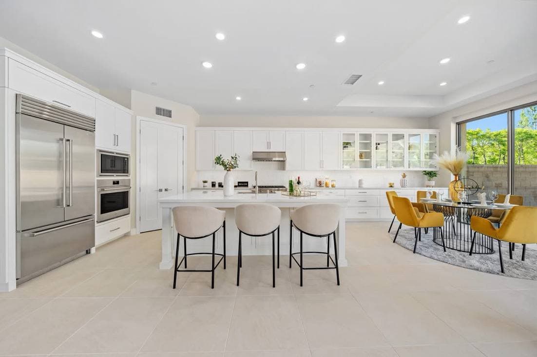 Custom chef kitchen with island seating and dining area