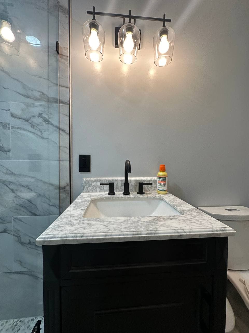 Custom marble shower with dual niches and matte black fixtures