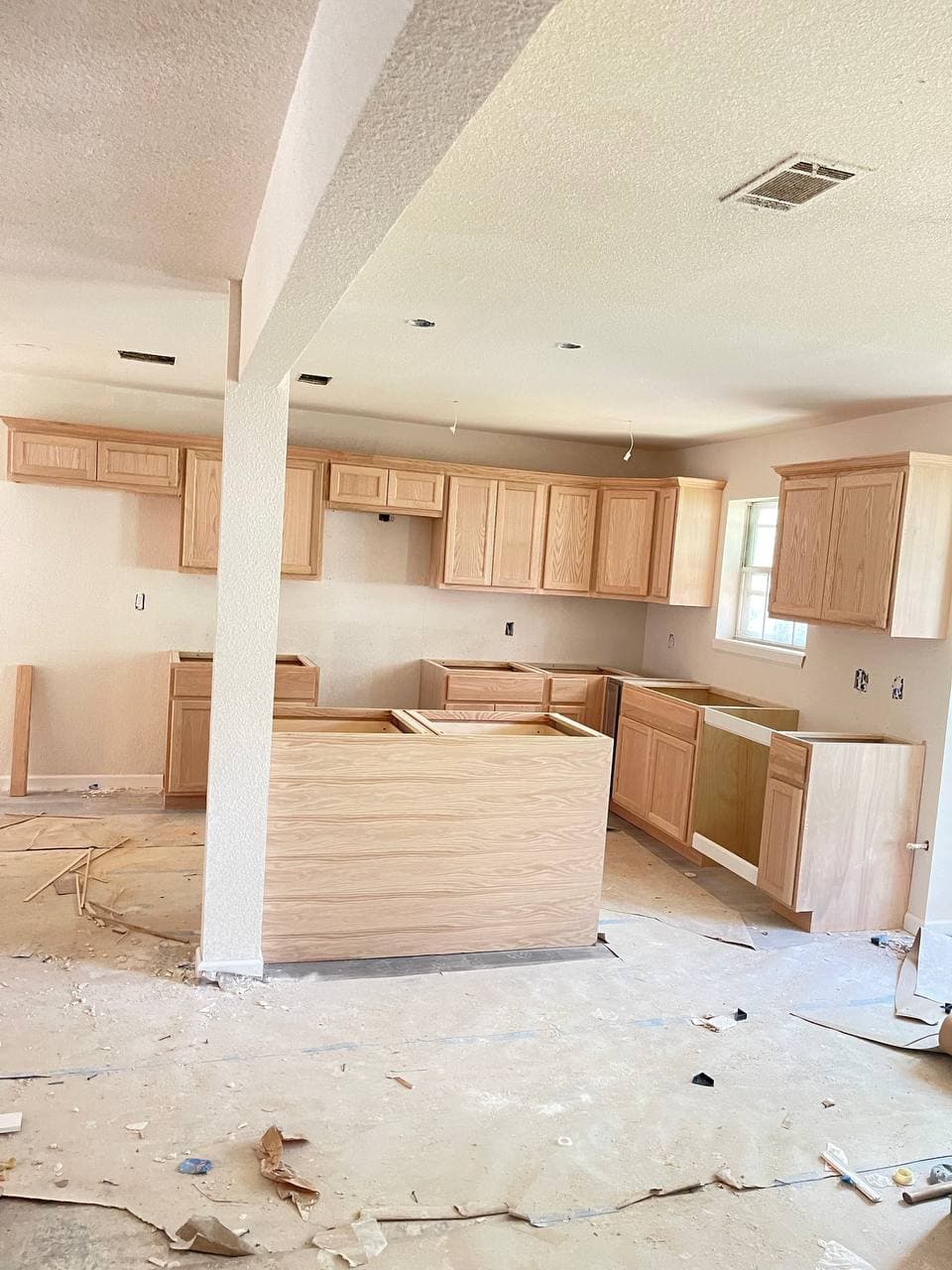 White kitchen remodel with granite countertops and new appliances