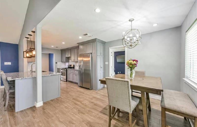 Full home renovation — kitchen and dining area with gray cabinets and granite