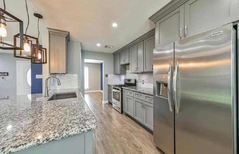 Kitchen with granite island and view to living area