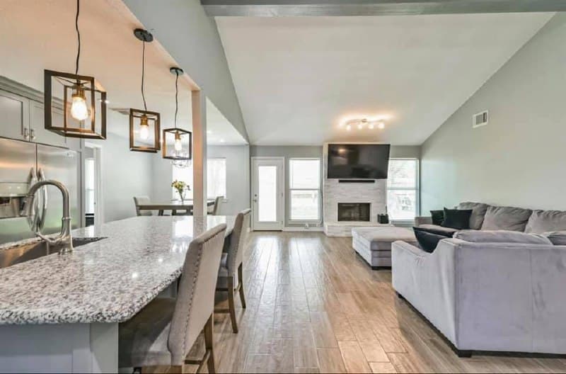 Full home renovation — vaulted living room with stone fireplace