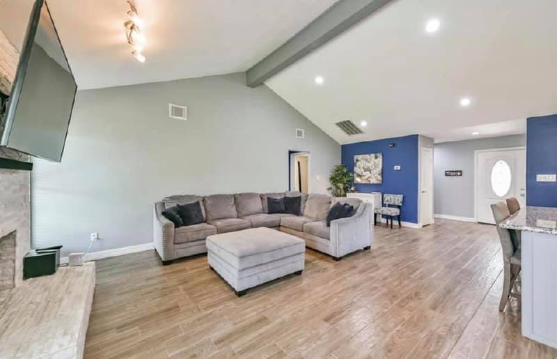 Vaulted living room renovation with fireplace and blue accent wall