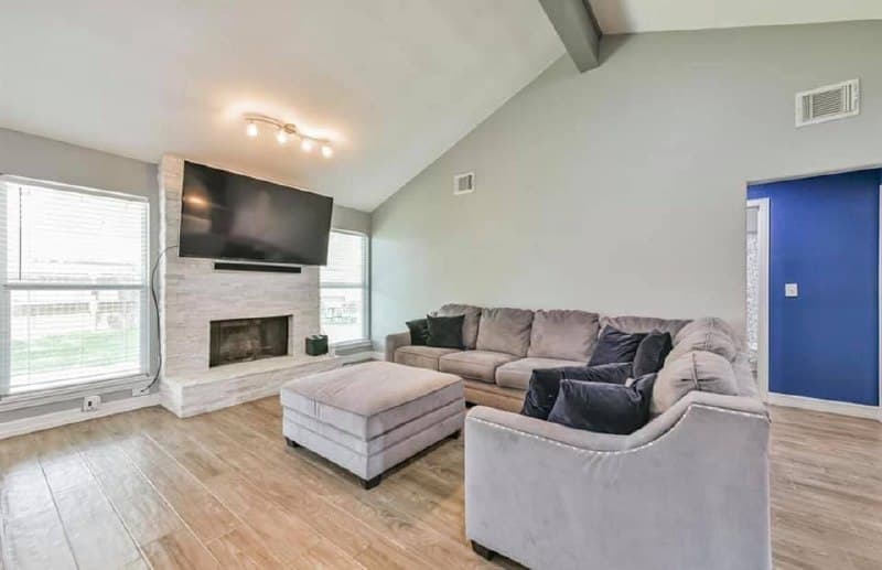 Living room renovation with fireplace and open floor plan to kitchen