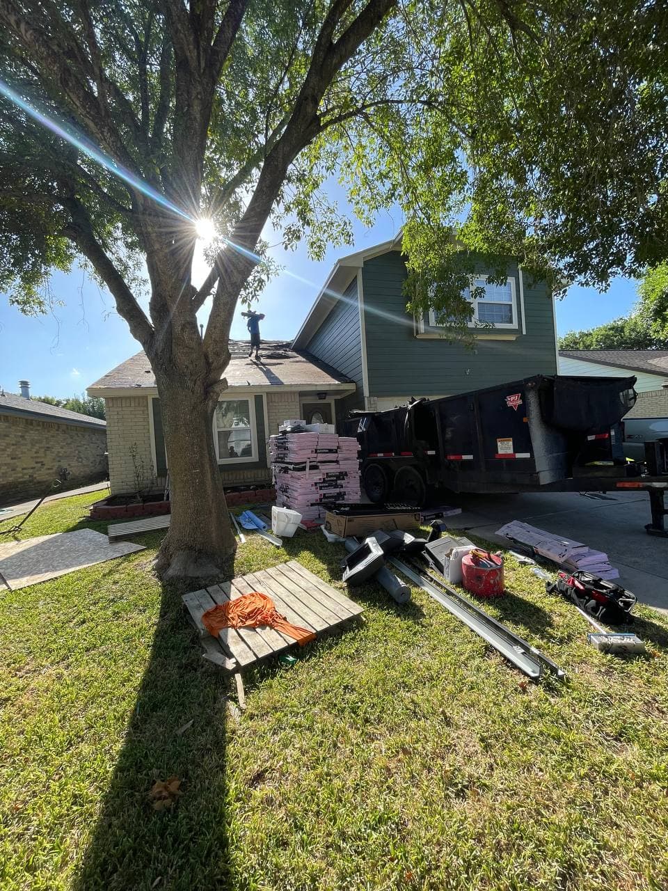 Roofing crew at work — shingle tear-off